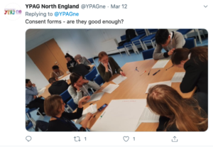 Screenshot of a tweet with YPAG members working on a sheet of paper